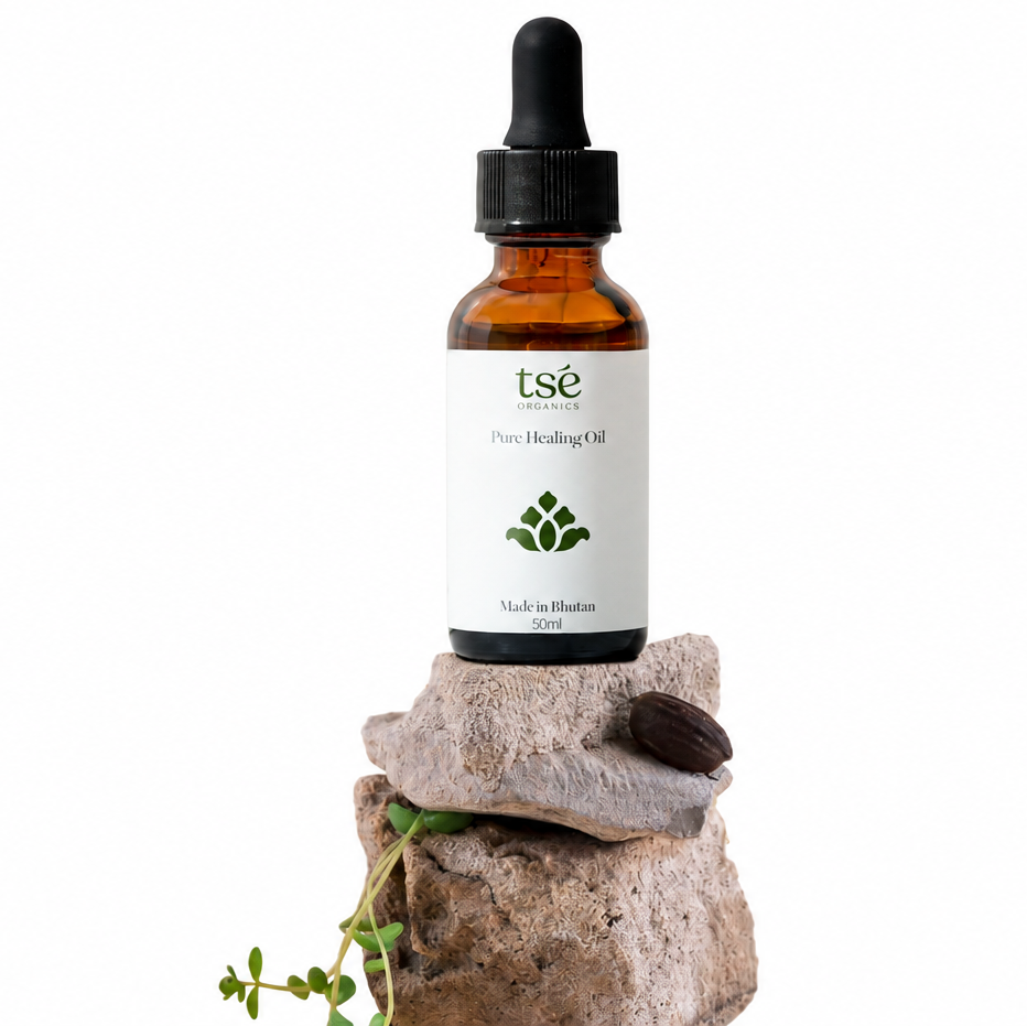 Tsé Pure Healing Oil bottle with green lettering on a stone pedestal